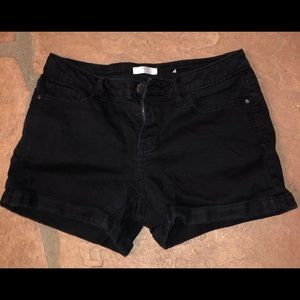 Women’s mid rise black denim shorts.